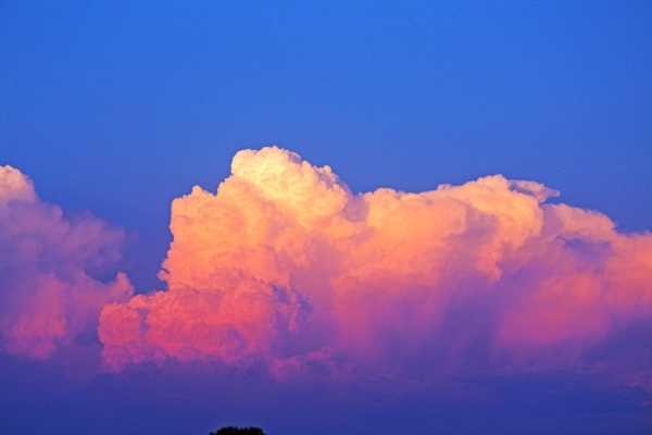 Photo of pink clouds against a blue sky. Photo by @wildhearts on Unspalsh.